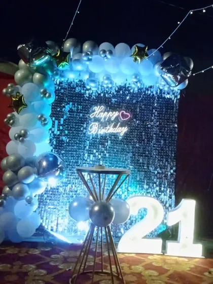 The same 21st birthday setup under cool blue lighting, creating a vibrant and energetic party mood.