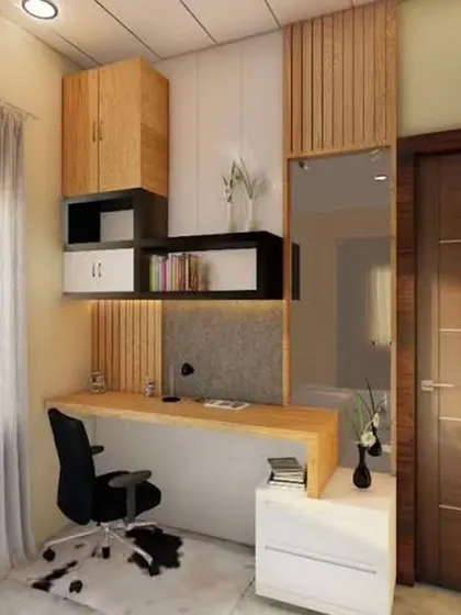 A well-lit study area next to a window, featuring a floating desk and a mix of open and closed overhead storage. Wood paneling adds warmth and texture.