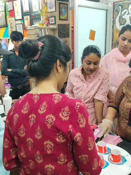 Students gathered around for a live demonstration during a resin art class. We believe in hands-on learning and close interaction with our instructors.