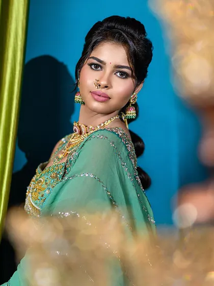 A direct and engaging portrait that gives a clear view of the semi-traditional engagement makeup, including the defined eyes and statement nose ring.
