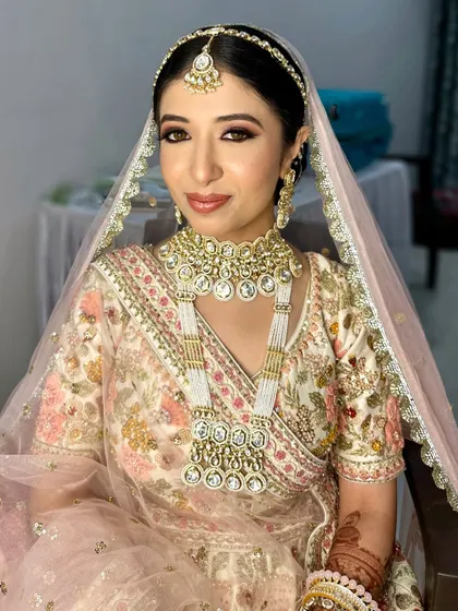 An afternoon bride in a lovely pastel lehenga. The makeup is soft and luminous, perfect for a daytime ceremony.