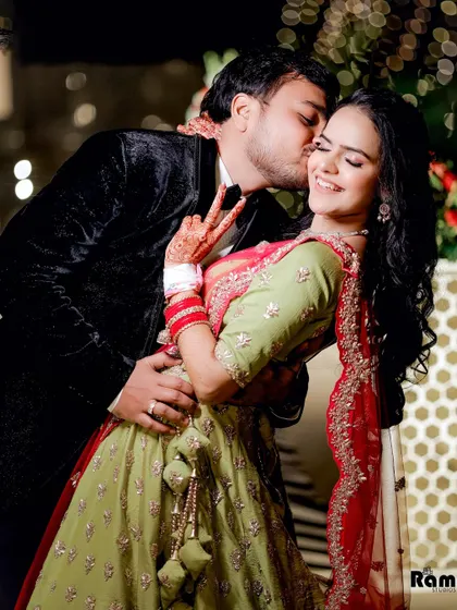 A playful and affectionate candid moment from a ring ceremony. The groom's kiss on the cheek and the bride's joyful expression perfectly capture the spirit of the celebration.