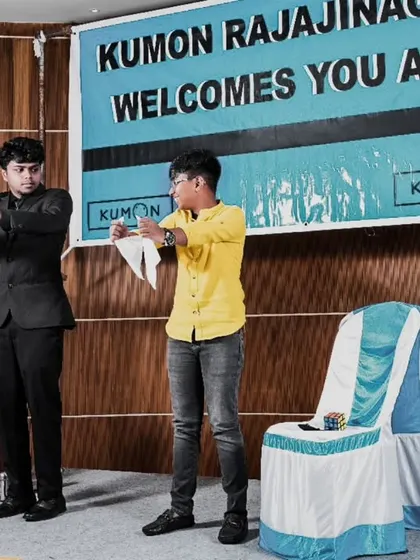 Two boys on stage, completely focused on learning a magic trick with me. I enjoy teaching simple illusions to my volunteers, making them part of the secret.