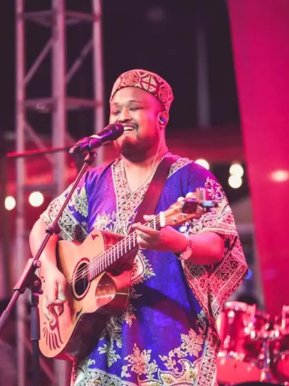 Expressing through music is a good addiction. A happy moment on stage, smiling while playing and singing for the crowd.