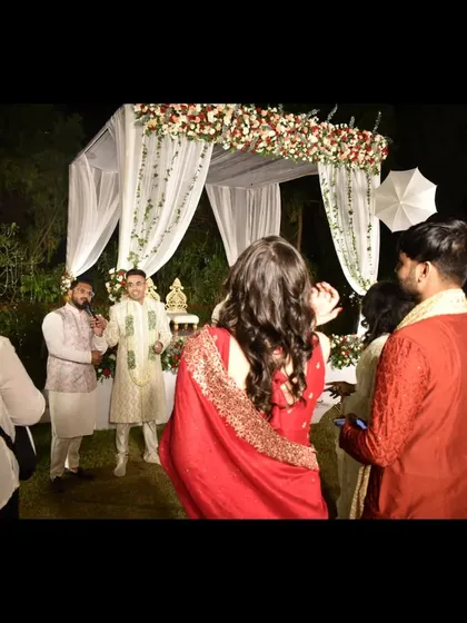 A beautiful Varmala ceremony under a floral mandap. I provide the commentary that makes this traditional moment even more magical.