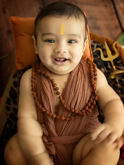 A happy baby Shiva. His bright smile and chubby cheeks bring so much joy to this spiritual-themed milestone shoot.