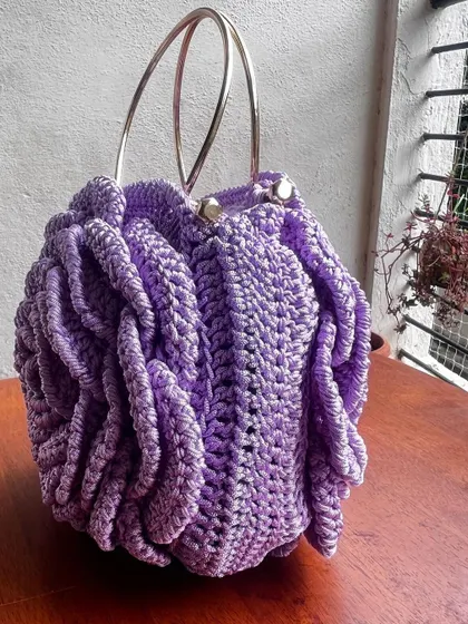 A side view of the lavender Rose Bag, showing its depth and the beautiful way the petals are layered.