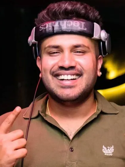 A smile for the camera before I drop the next track. I love what I do, and I think it shows.