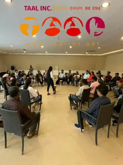 This image captures the essential ingredients of our drum circles: a group, an expert facilitator, drums, and a shared objective. It’s a simple recipe for creating effortless quality and connection in a corporate setting.