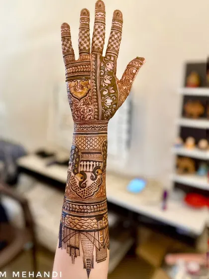 This design shows how we can blend modern ideas with traditional art. I combined a detailed cityscape of a place special to the client with classic Indian motifs like peacocks and jaali patterns, creating a full-arm design that is both personal and beautiful.