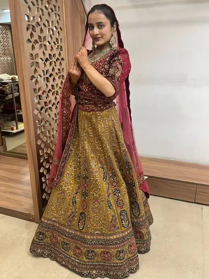 The rich fabrics and detailed embroidery make this bridal lehenga a stunning choice for your wedding day.
