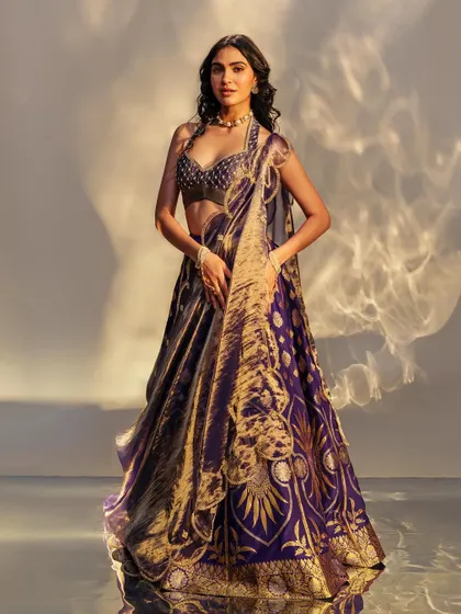 This dramatic aubergine Benarasi lehenga is a showstopper. The intricate gold weaving and modern cut make it a perfect choice for a bride who wants a blend of tradition and high fashion.
