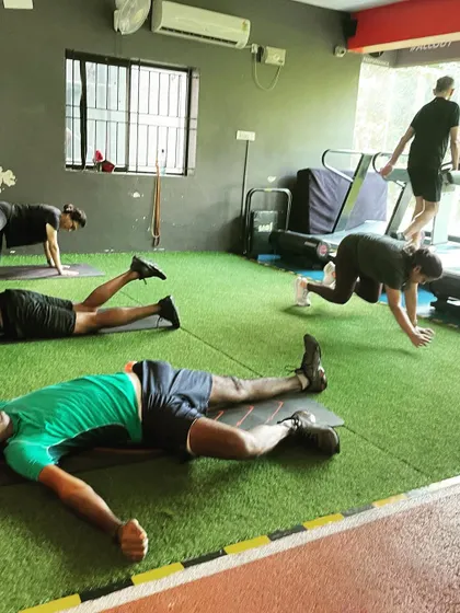 The aftermath of a tough session. Clients rest and stretch on the floor, a sign of a workout well done.
