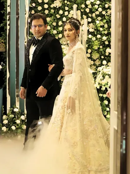 Another shot of the couple's grand entrance, with dramatic smoke. The bride's makeup remains flawless and radiant.