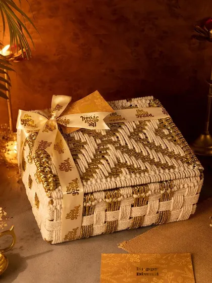 Our premium white and gold Diwali hamper, closed and tied with a custom ribbon. This reusable box is a gift in itself, perfect for creating a lasting impression.