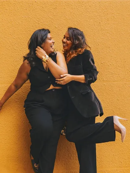 A candid shot with a friend. I designed my own black waistcoat and pants set for this photoshoot. It's a great example of the custom modern wear I can create for any occasion.