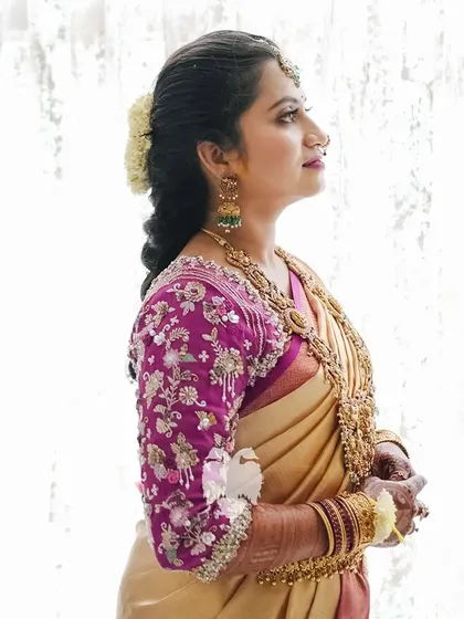 Another shot of Kavya, her intricately embroidered blouse a perfect match for her gold jewelry.