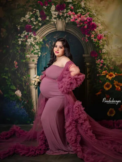 Another angle of the ruffled gown, showcasing its texture and flow. The floral backdrop adds to the romantic, fairytale vibe.