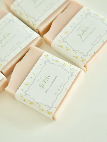 A close-up of the custom-labeled soaps for a baby shower in Amsterdam, showing the delicate floral design.