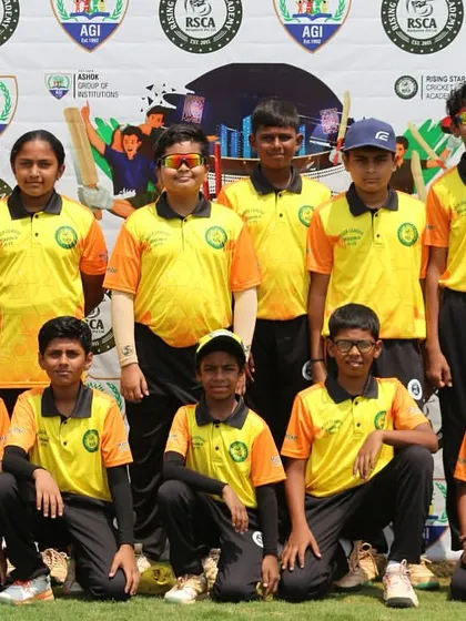 A team in yellow and orange jerseys poses for a group photo during the RSCA League.