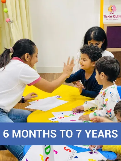 A trainer and a child share a high-five, celebrating a small victory. We foster a positive and encouraging environment where every child feels confident and successful.