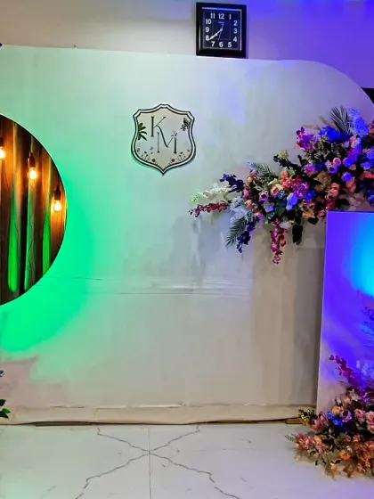 The same modern engagement backdrop, shown here with colorful mood lighting in green and blue to completely change the vibe for the evening party.