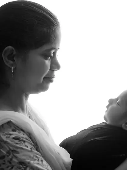 Another beautiful high-contrast, black and white portrait of a mother admiring her newborn. These minimalist shots focus purely on the emotion and connection.