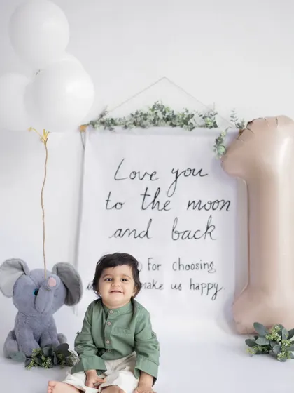A heart-melting smile from the birthday boy. Our clean, white studio background is perfect for creating timeless first birthday portraits that focus entirely on your child.