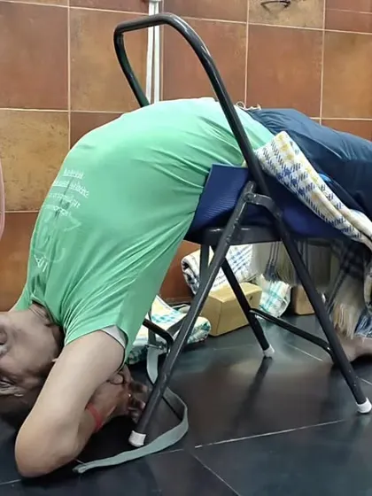 A supported backbend over a chair, a classic Iyengar yoga technique. This helps to open the thoracic spine and shoulders safely, preparing the body for deeper backbends.
