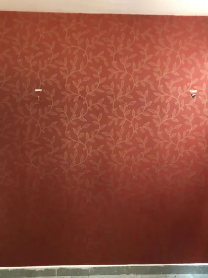 A bold, red wallpaper with a gold leaf pattern. This creates a warm and dramatic accent wall.