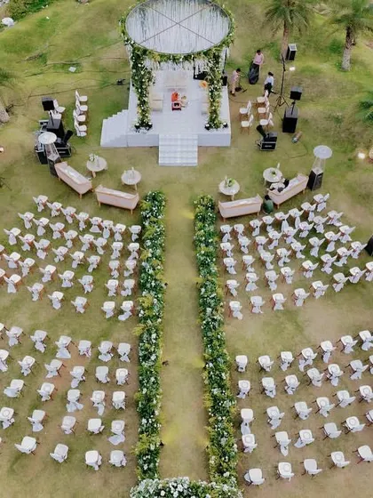 From a bird's eye view, you can see the whole story. We designed this luxe garden wedding in Udaipur to feel grand yet intimate, with a stunning circular mandap and a floral-lined aisle that created a breathtaking path to 'I do'.