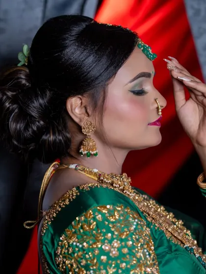 A side profile showing the elegant updo and the eye makeup.