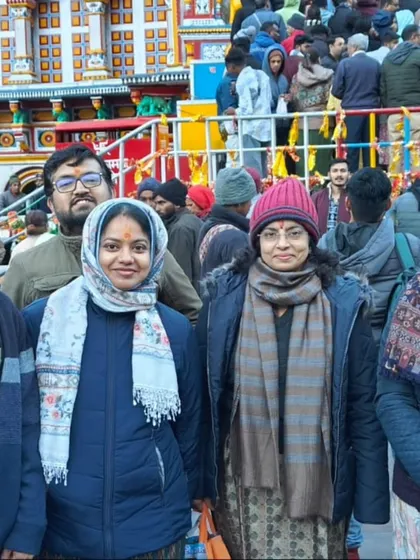 **Family and Friends at Badrinath Temple.** A group of devotees, warmly dressed, posing together outside the colorful Badrinath temple.