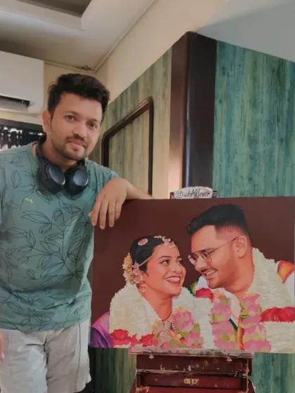 The artist with the finished anniversary portrait. It's so fulfilling to see a client's favorite memory transformed into a tangible piece of canvas art.