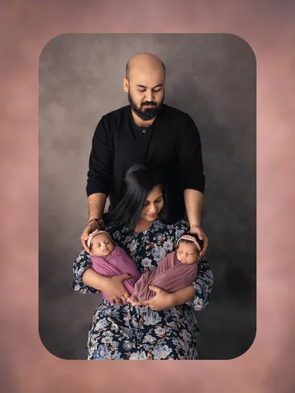A creative and intimate family portrait with twins. This pose beautifully symbolizes the parents as the foundation of their new family.