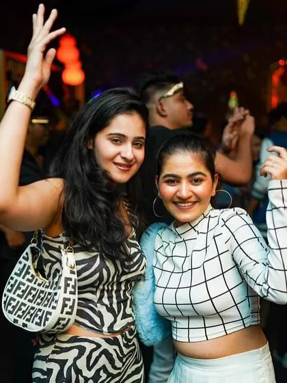 Two friends enjoying the vibe at Badmaash on a Sunday night. It's the perfect way to end the weekend on a high note.