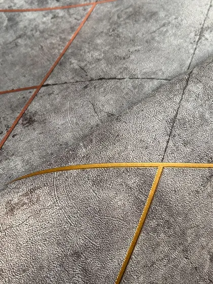 Another angle of the grey geometric wallpaper, highlighting the subtle texture and the clean, modern lines that make it a luxurious choice for home decor.