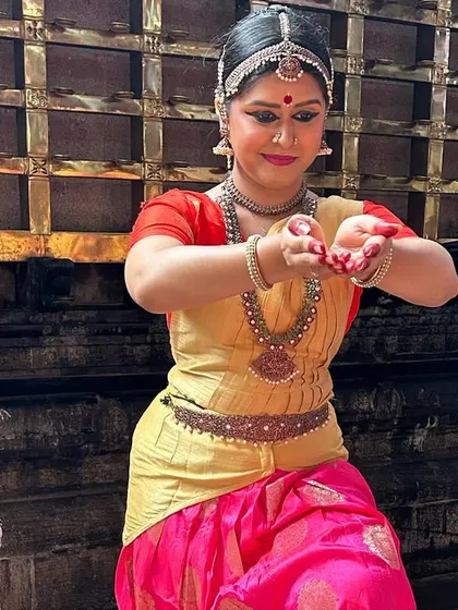 Performing in full traditional costume at a temple during a dance tour. The architecture and spiritual energy of such places provide a powerful backdrop, making the dance an offering of Pushpanjali, or a handful of flowers, to the deity.