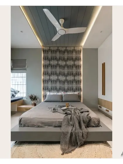 This perspective shows the full length of the bedroom, highlighting the floating bed design and the striking patterned wallpaper that serves as a headboard, framed by subtle LED strip lighting.