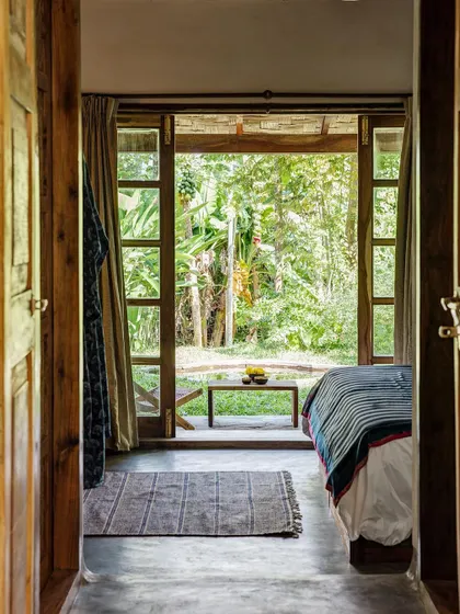 Looking from the Garden Room bedroom out to its private patio and garden, a perfect example of indoor-outdoor living.