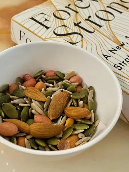 A handful of mixed nuts and seeds is a great snack to have when hunger strikes. It's rich in healthy fats, fiber, and micronutrients like zinc from pumpkin seeds. Plus, it's easy to carry with you anywhere.