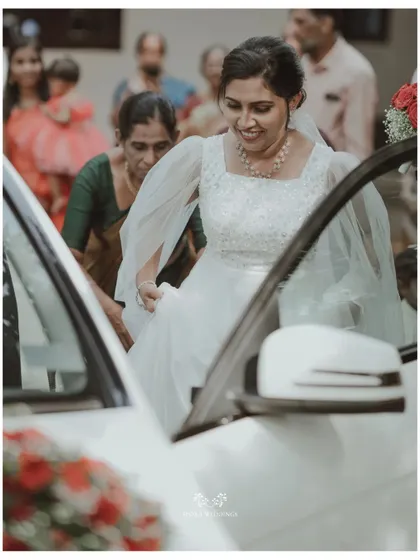 The bride stepping out of her wedding car, a moment of transition and excitement captured beautifully.