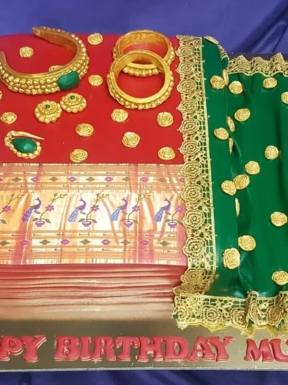 A tribute to timeless elegance. This cake is designed to resemble a traditional silk saree with intricate gold jewelry, all completely edible. It's a beautiful and personal way to celebrate a mother's birthday.