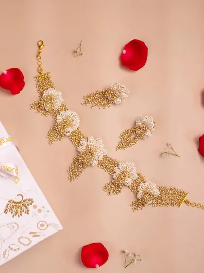 A beautiful shot of a handcrafted floral choker set against a soft background with scattered rose petals. This image was part of a special Valentine's Day collection shoot.