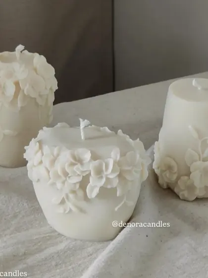 My floral pillar candles are a beautiful way to bring botanical elements into your decor. This image shows three different designs with 3D floral reliefs.
