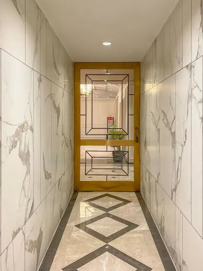This corridor in our Bhopal project features a striking geometric door and patterned marble flooring. We use hallways and transitional spaces as opportunities to continue the design narrative and surprise guests.