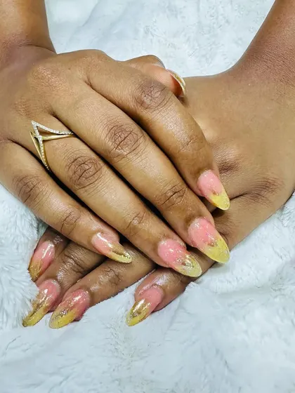 A unique combination of pink and yellow with gold foil flakes embedded within the nail.
