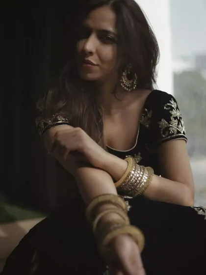 This portrait uses shadows and a seated pose to create a feeling of quiet confidence. The focus is on her expression and the beautiful details of her ethnic wear, showing how mood and style can be conveyed through posture and light.