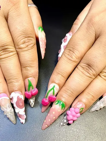 A fun and fruity set of nails with 3D cherries, grapes, and other fruits. This playful design shows the versatility of 3D nail art.