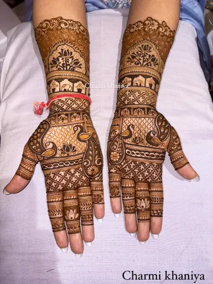 A gorgeous design for the groom's sister! It features peacocks, lotuses, and elephants, all the classic motifs for a festive celebration.